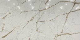 A sample of quartz countertop with beige and gray veining.