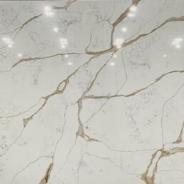 A sample of quartz countertop with beige and gray veining.